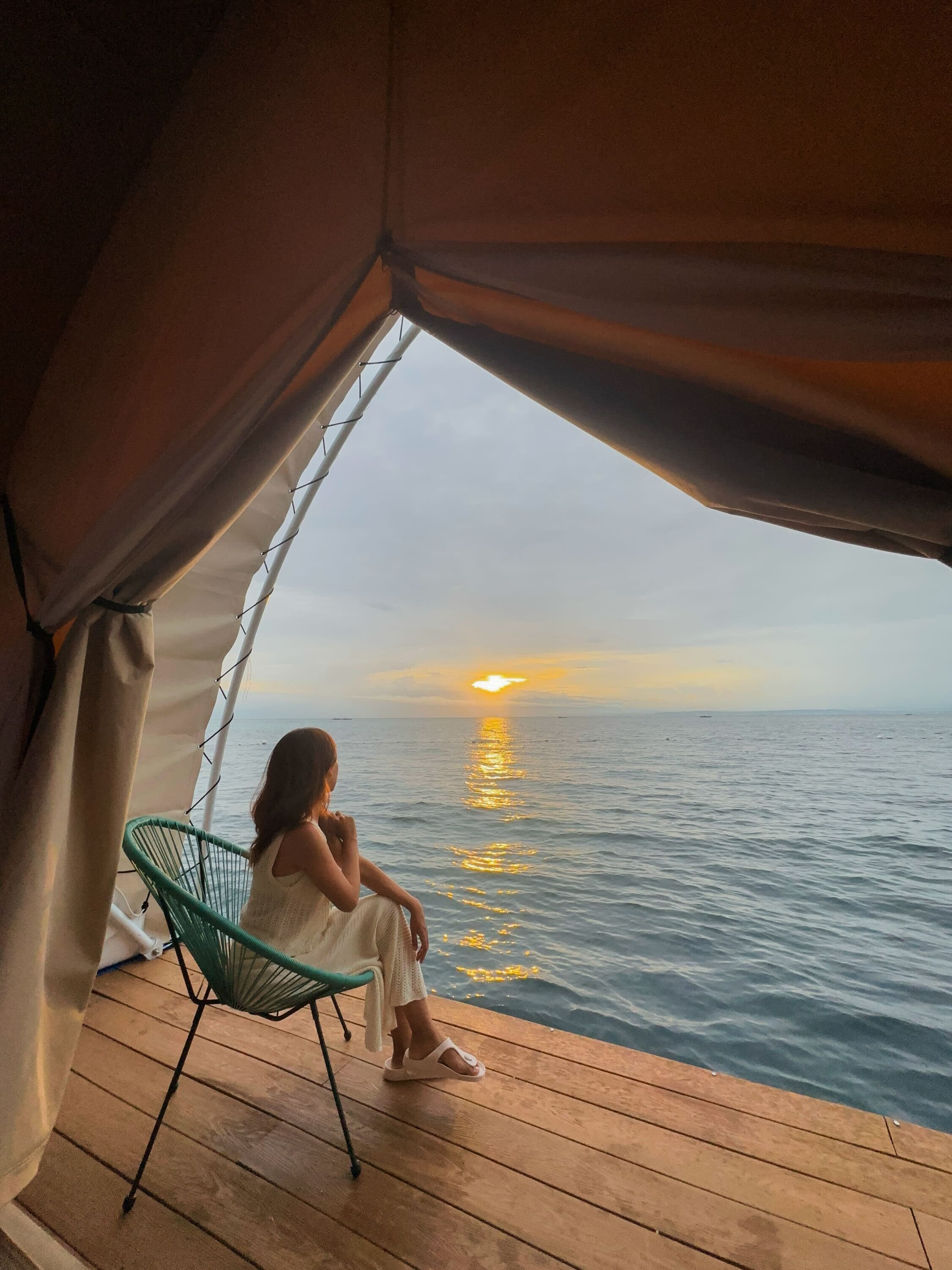 Sunset view from glamping tent over the ocean