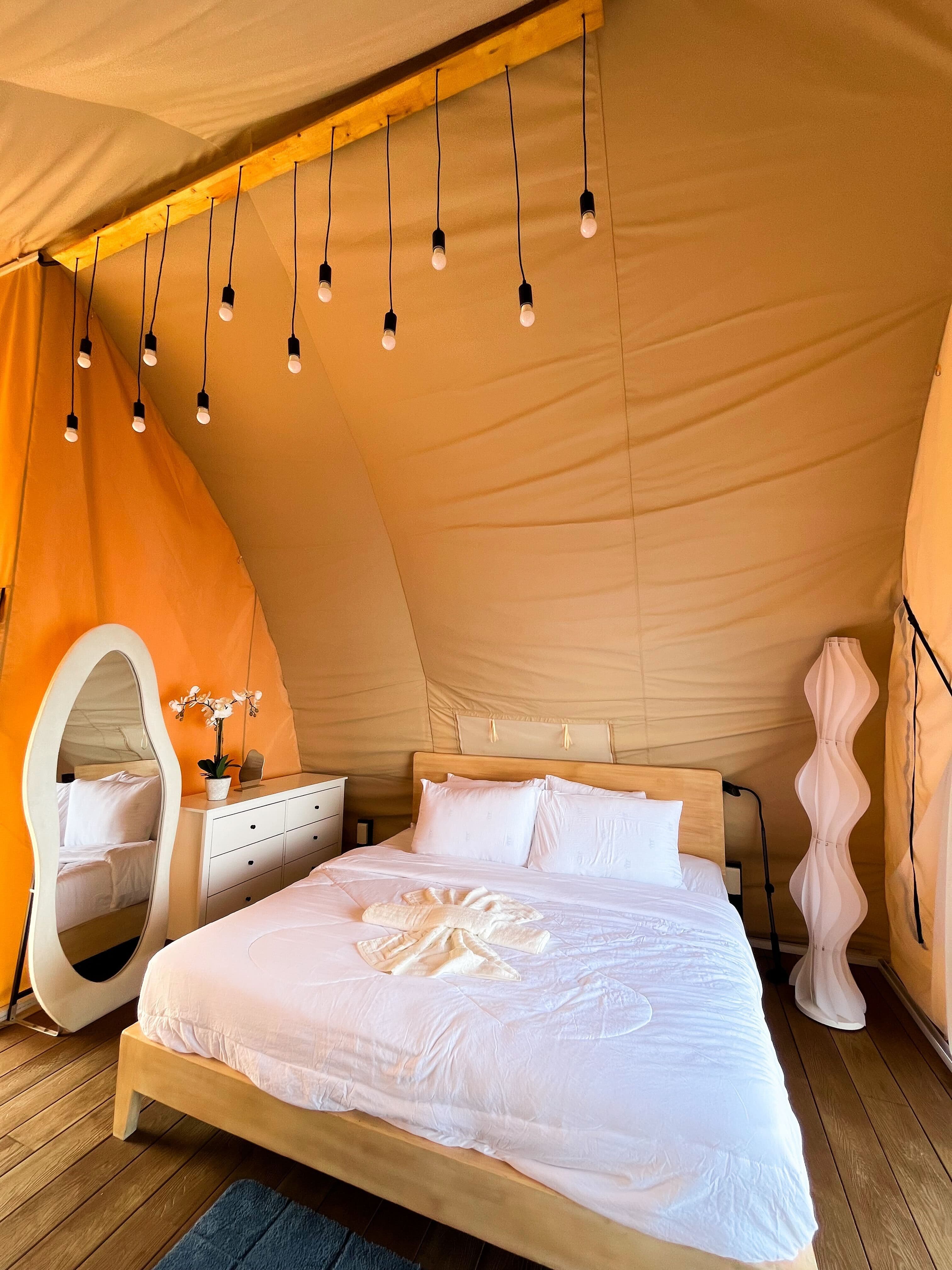 Luxury floating tent bedroom with string lights